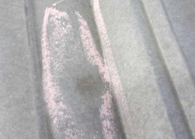 Dented metal roof from hail strike